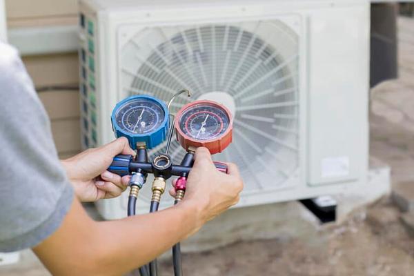 New high-efficiency gas furnace being installed to replace an aging unit in a Dallas home